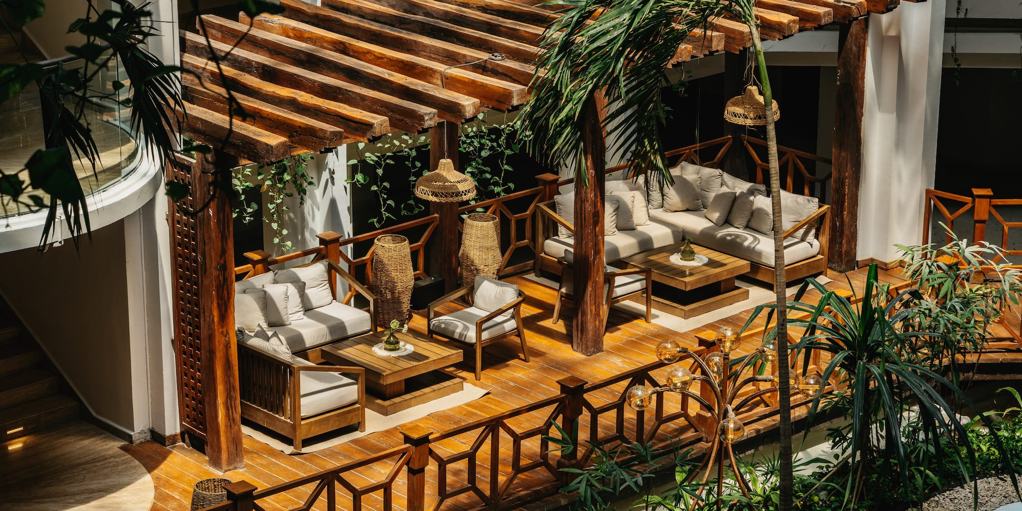 a pool with straw huts and a beach
