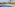 Sunny resort pool with beach, palm trees, and straw umbrellas.