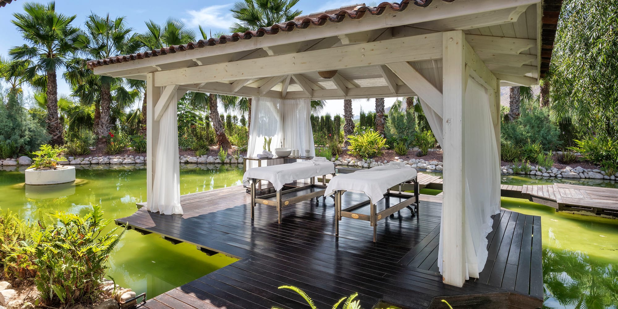 a wooden structure with tables and chairs on it