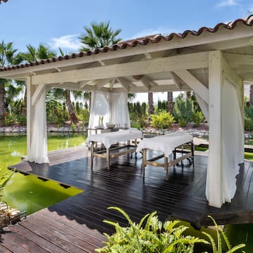 a wooden structure with tables and chairs on it