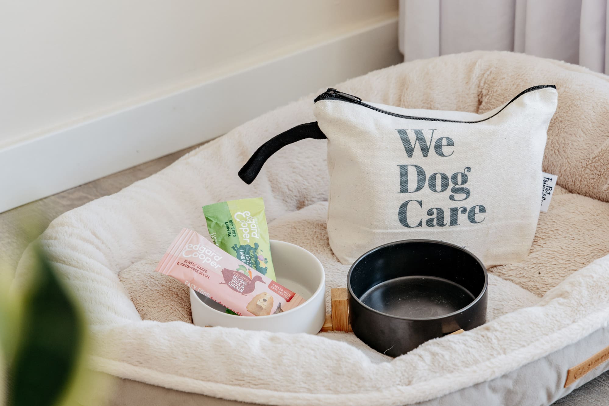 a dog bed with food and a bag on it