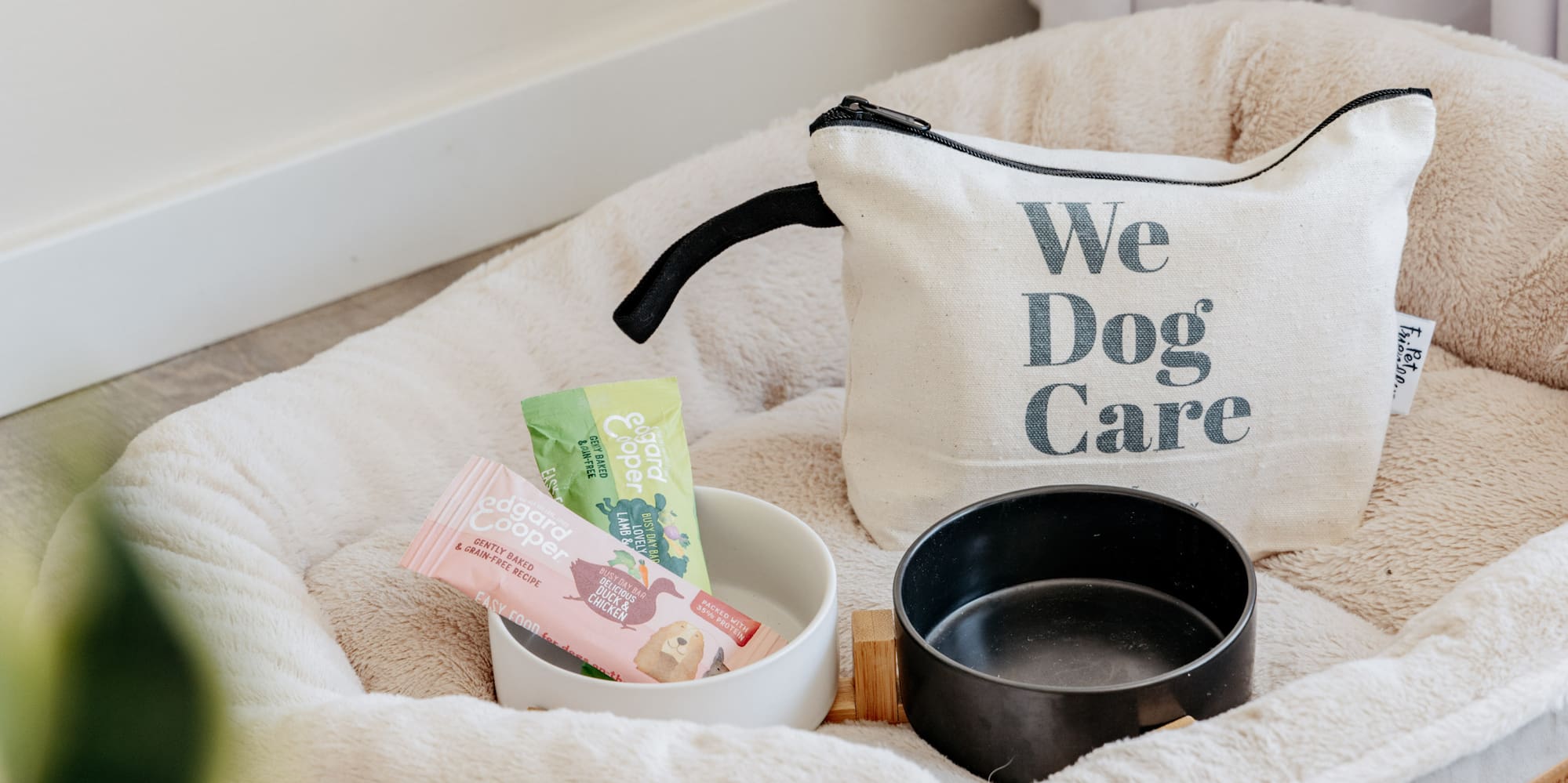 a dog bed with food and a bag on it