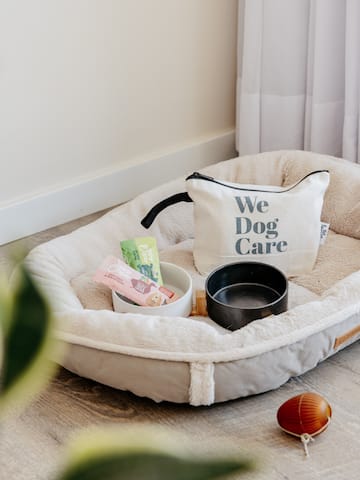 a dog bed with food and a bag on it