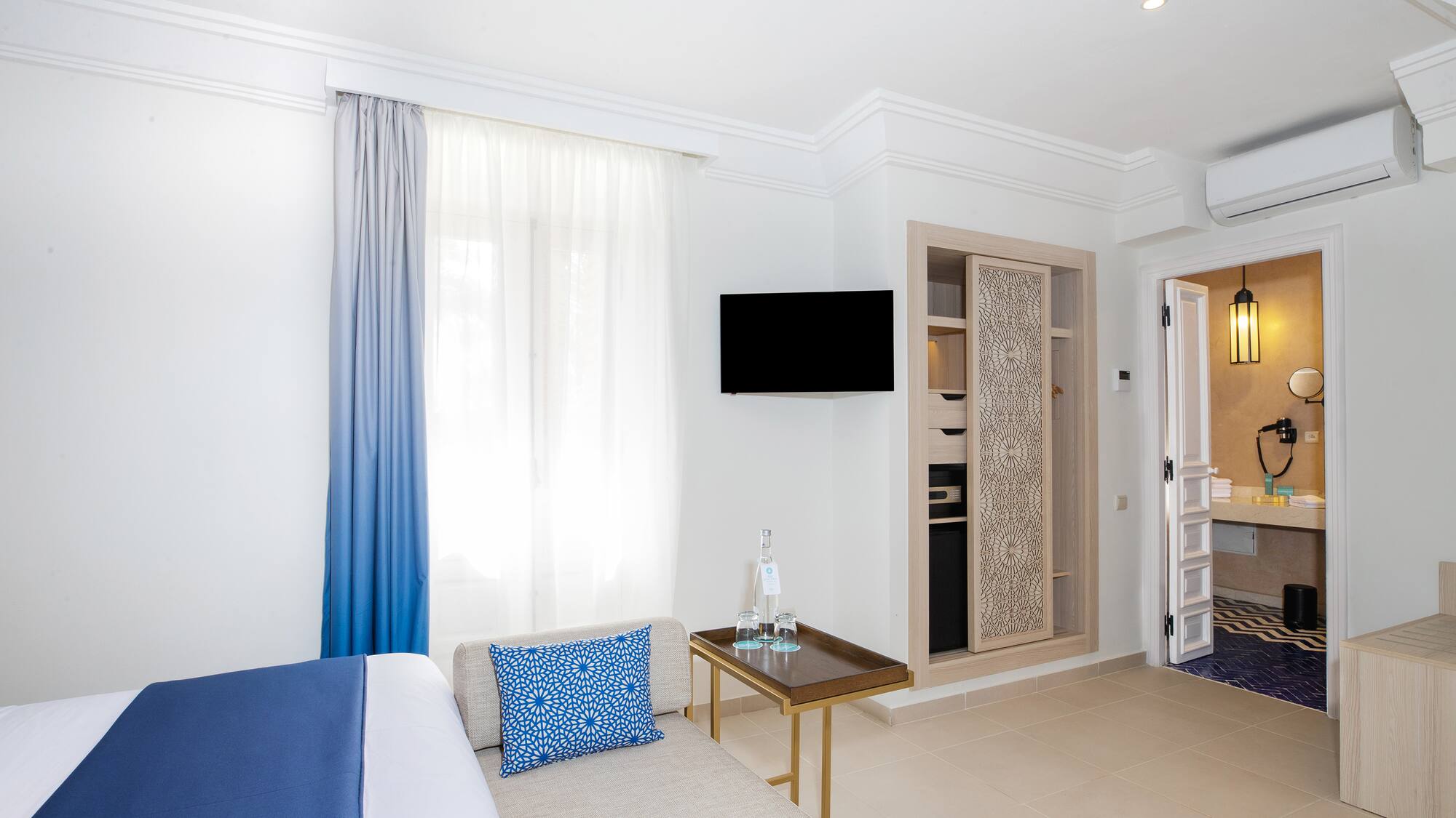 a room with a bed and a tv