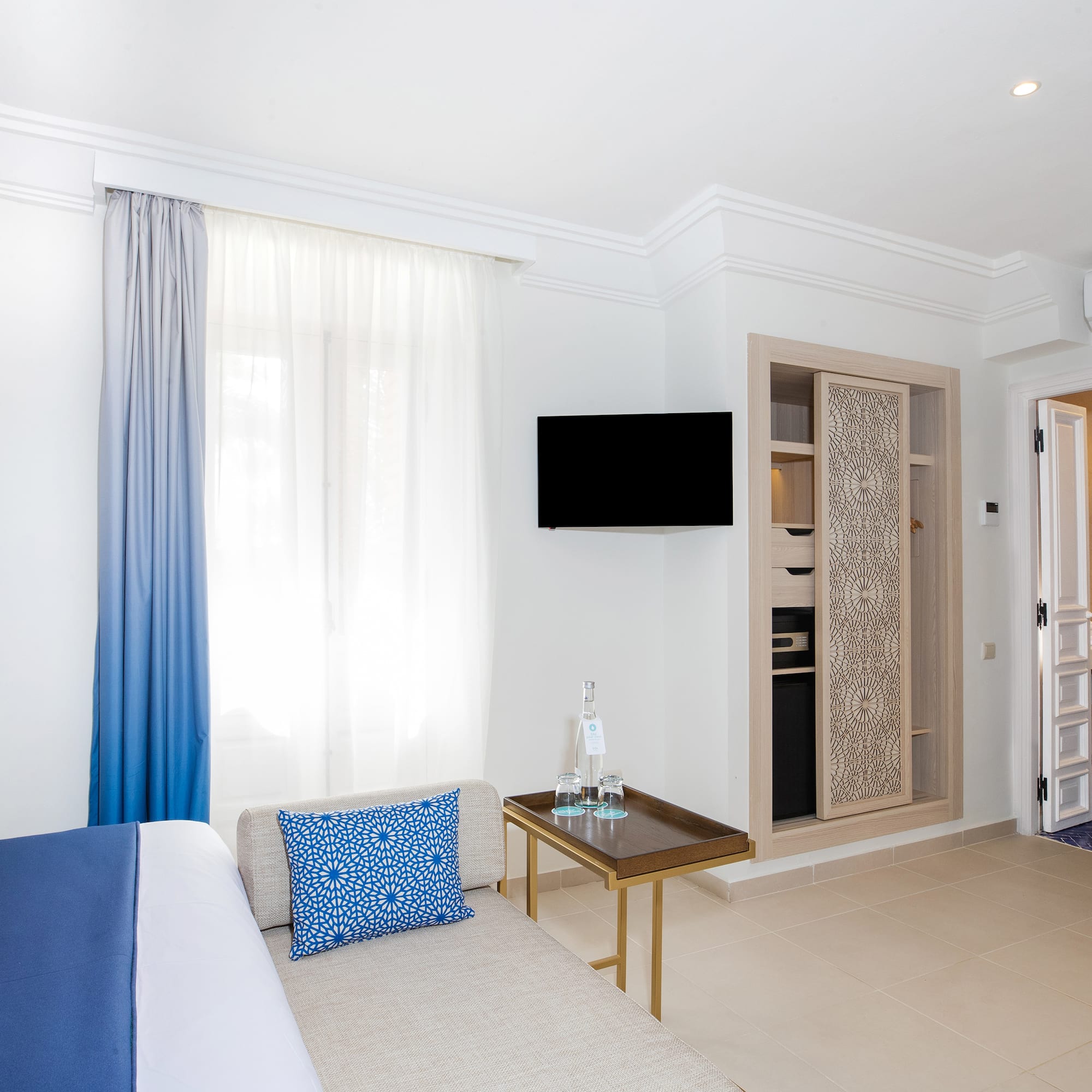 a room with a bed and a tv