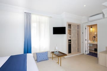 a room with a bed and a tv