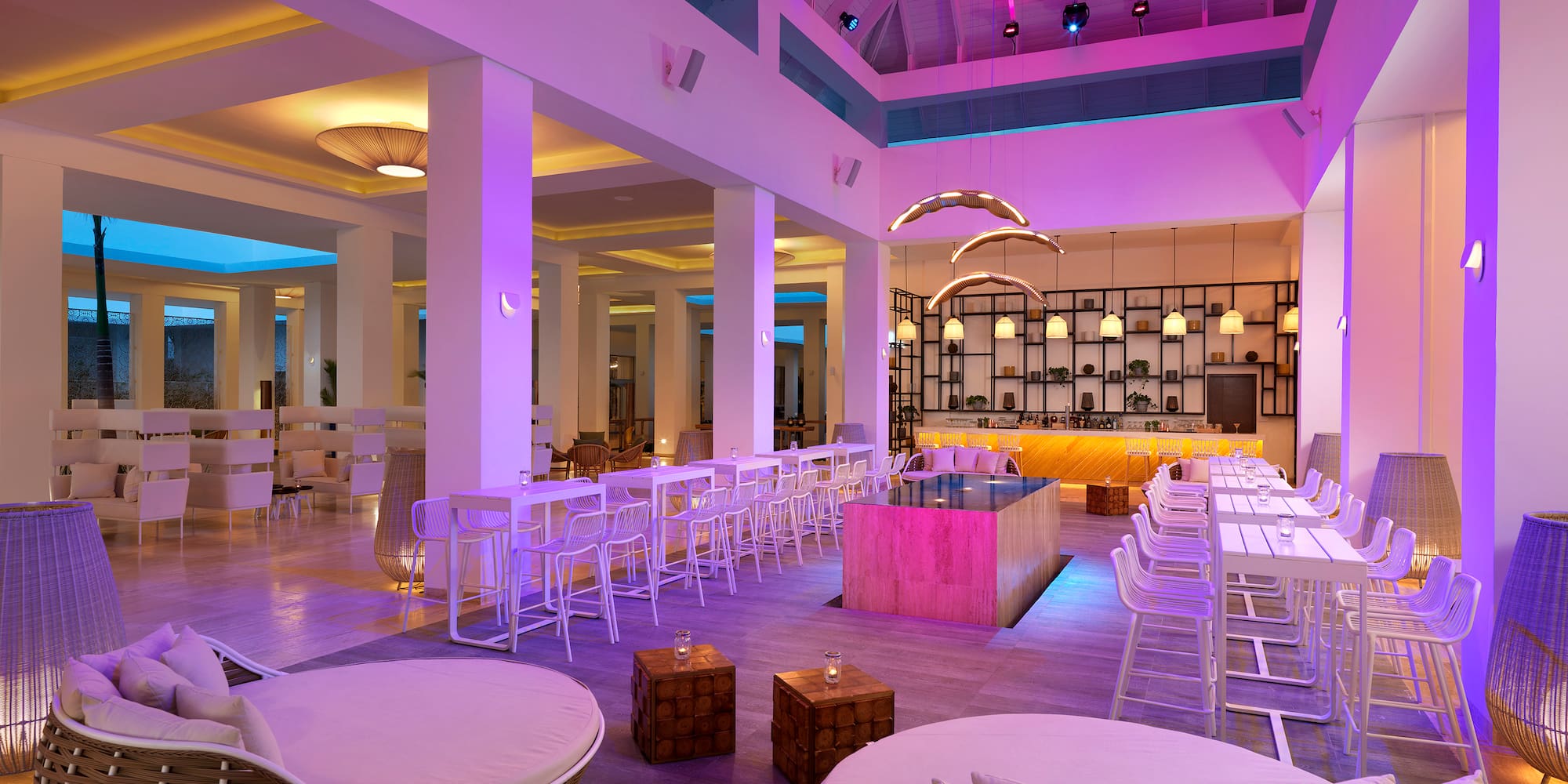 a room with white chairs and tables