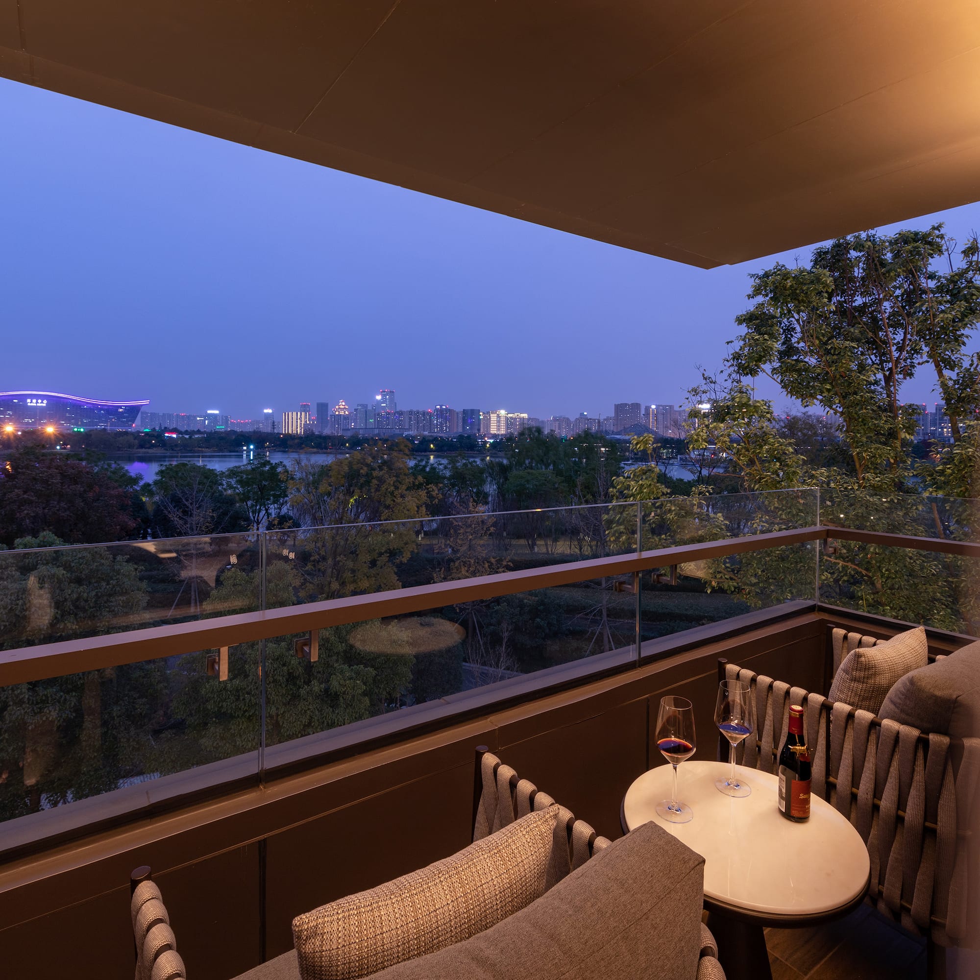 a balcony with a table and chairs and a city view