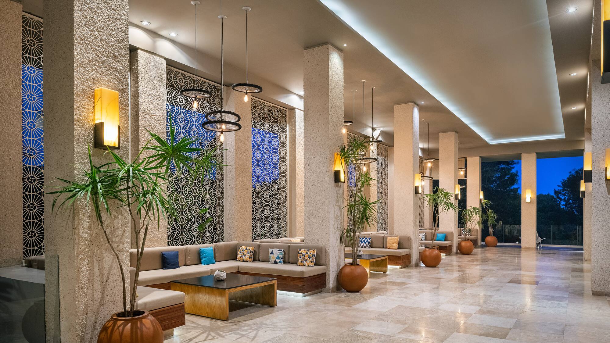 a long hallway with a couch and plants