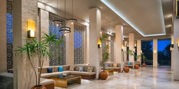 a long hallway with a couch and plants