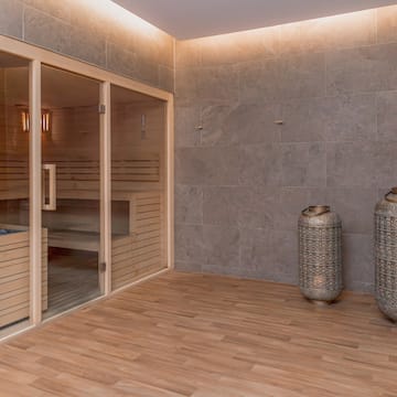 a sauna room with two large jars and a glass door