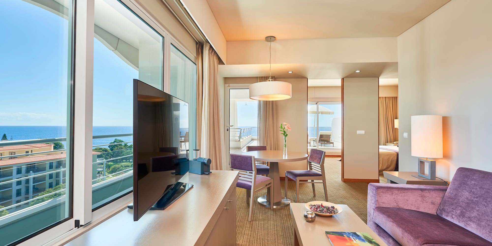 a room with a television and a table and chairs