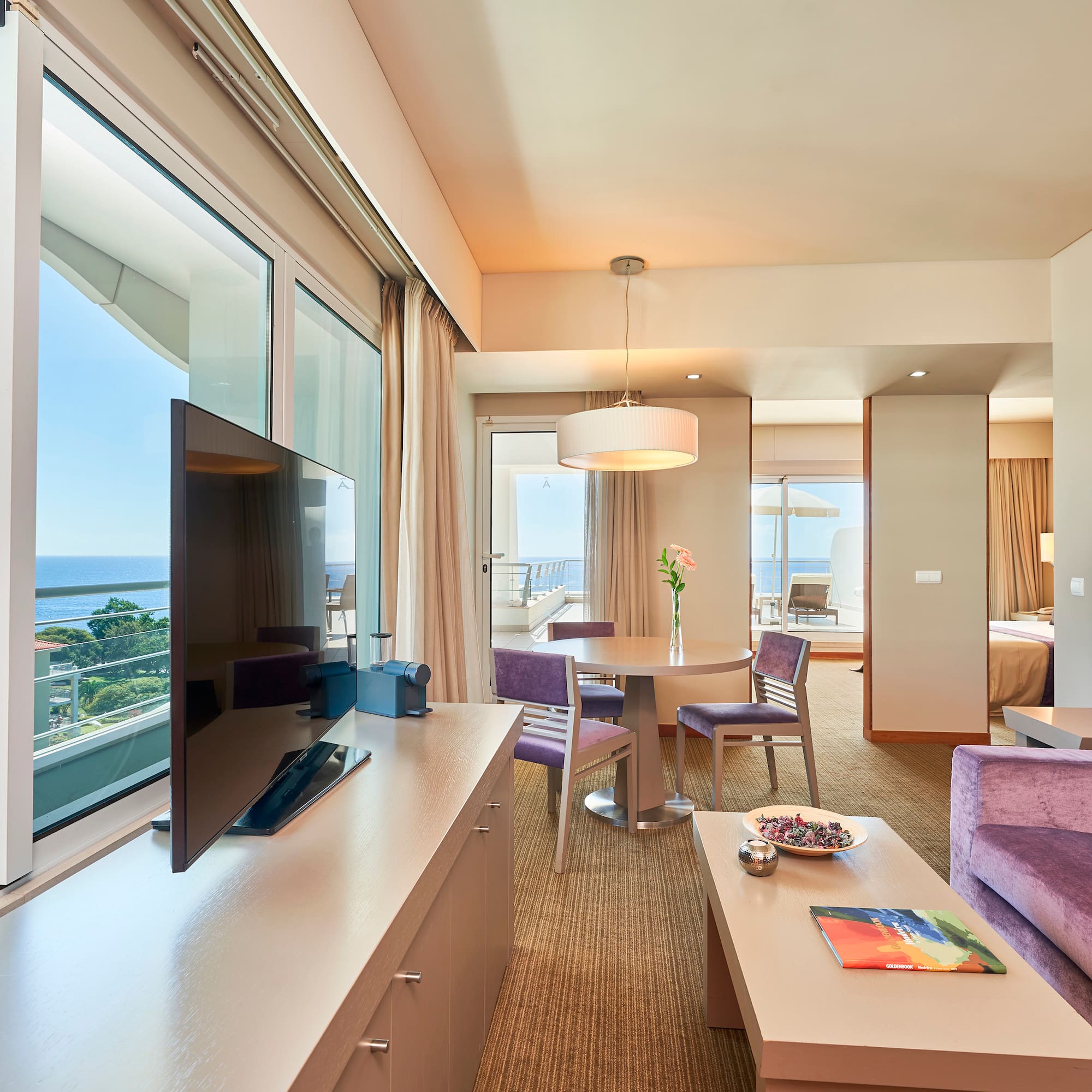 a room with a television and a table and chairs