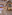 Hotel lobby bar with patterned columns, wooden beams, and lounge seating.