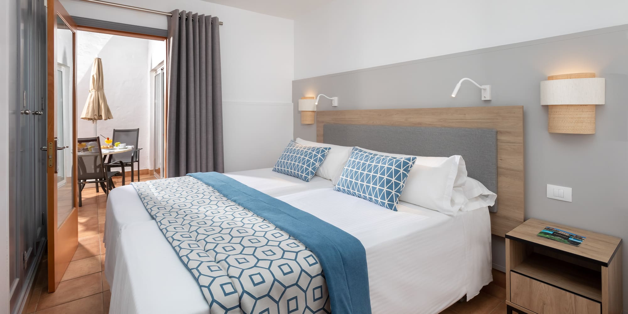 a bed with blue and white pillows