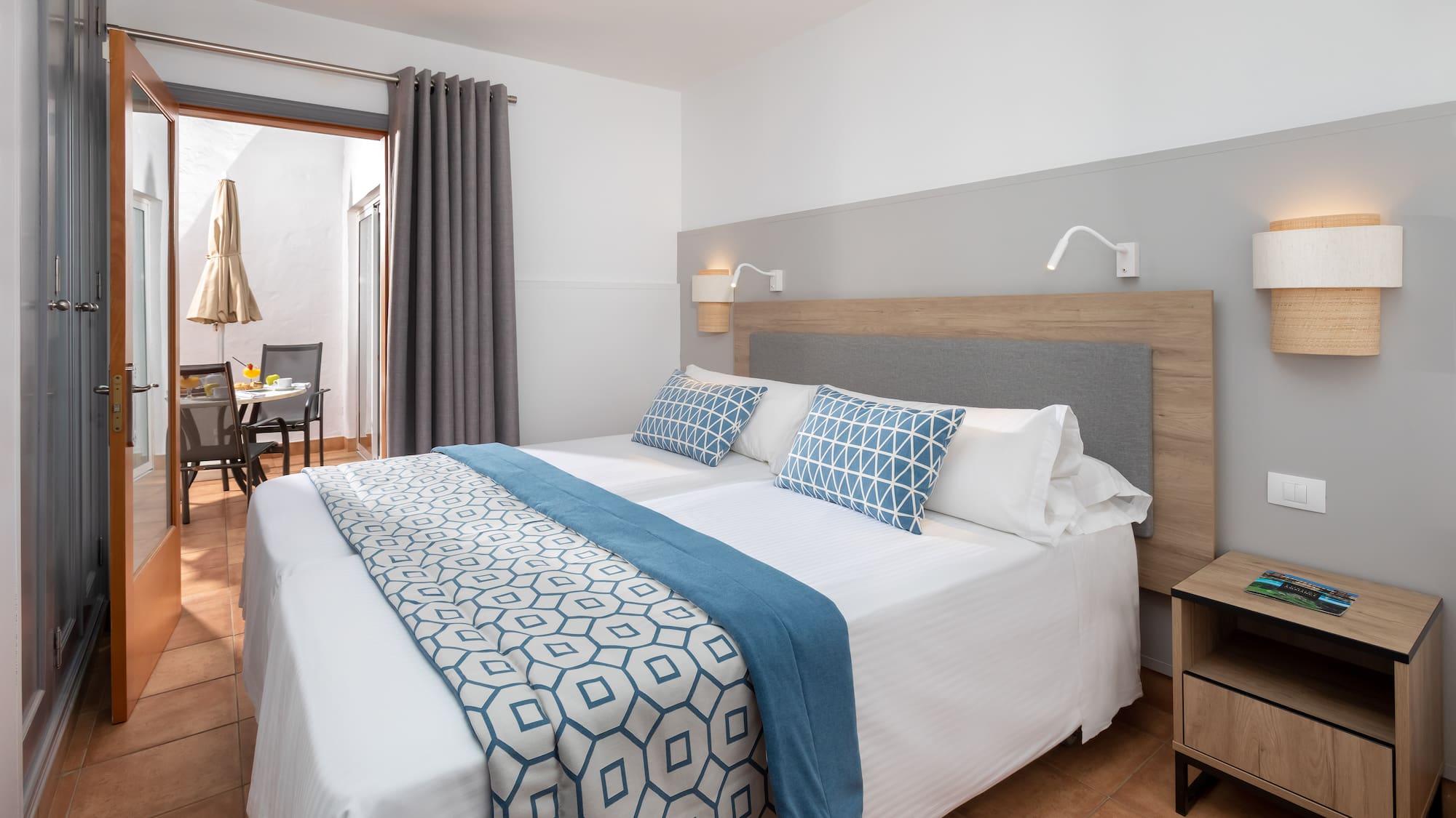 a bed with blue and white pillows