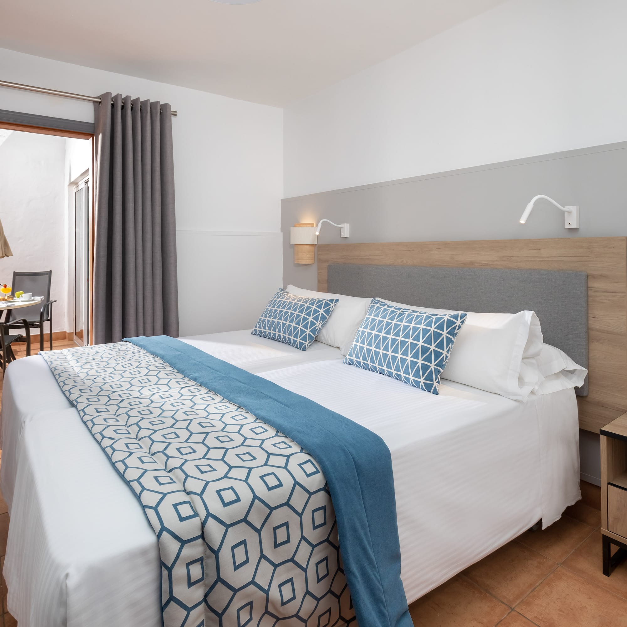 a bed with blue and white pillows