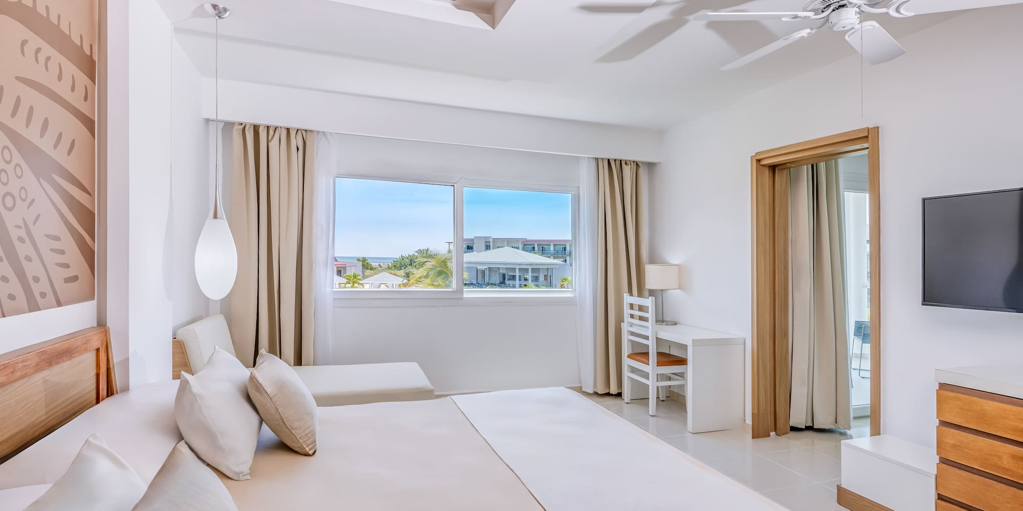 a bedroom with a large bed and a ceiling fan