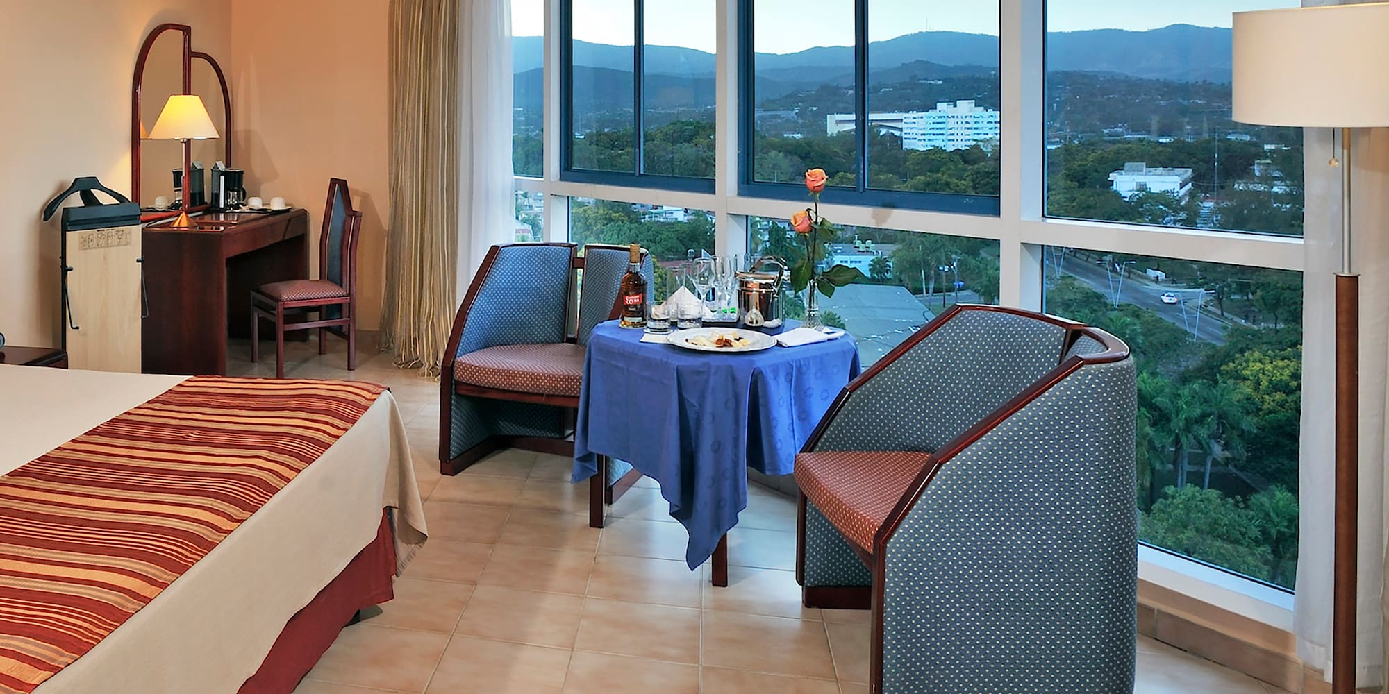 a room with a table and chairs and a view of the city