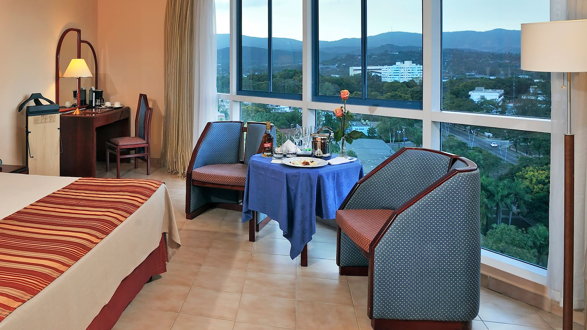 a room with a table and chairs and a view of the city