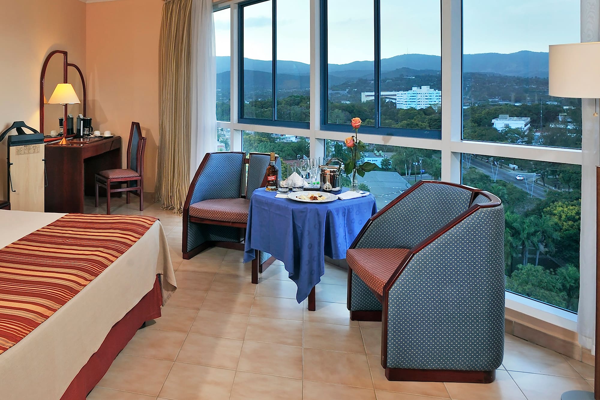 a room with a table and chairs and a view of the city
