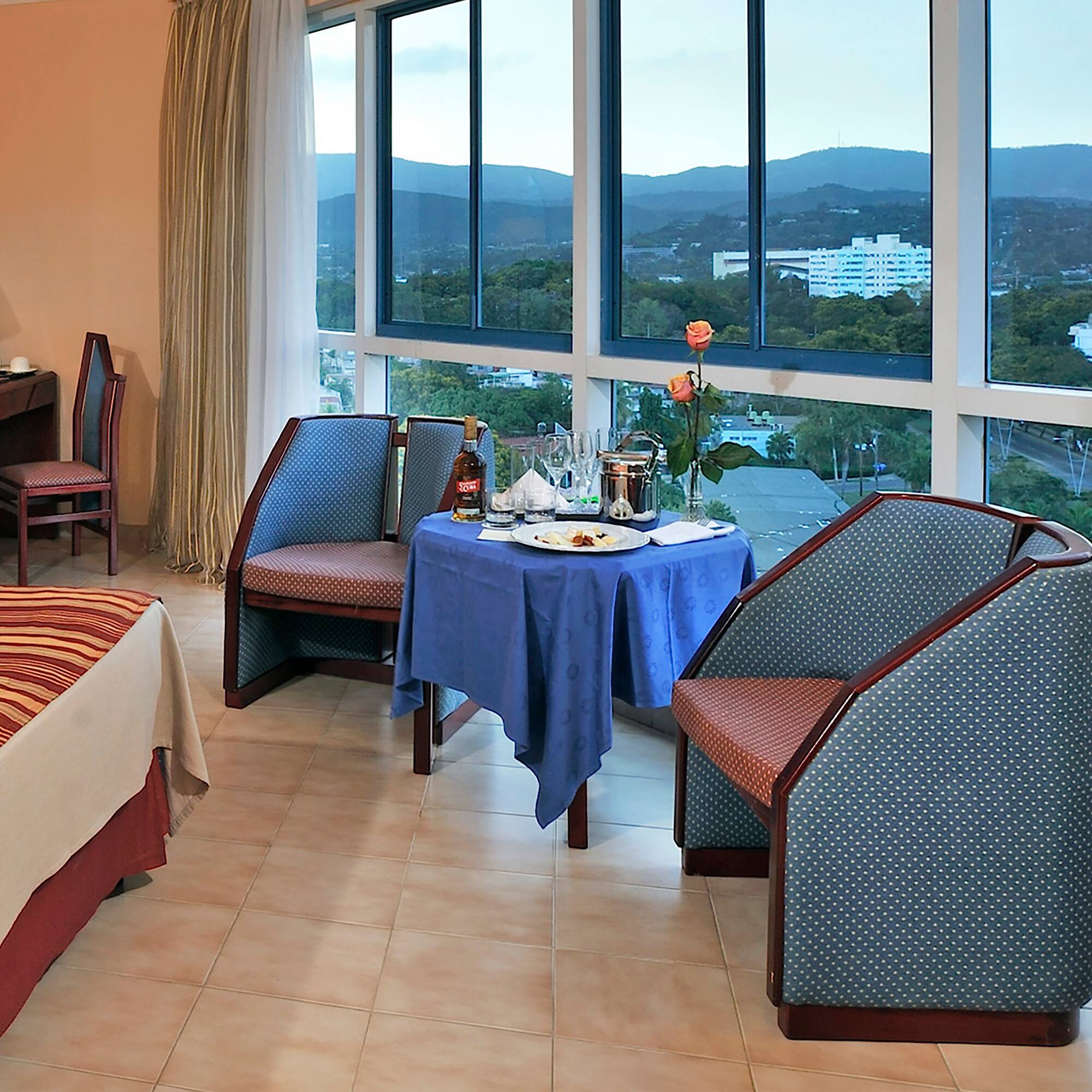 a room with a table and chairs and a view of the city