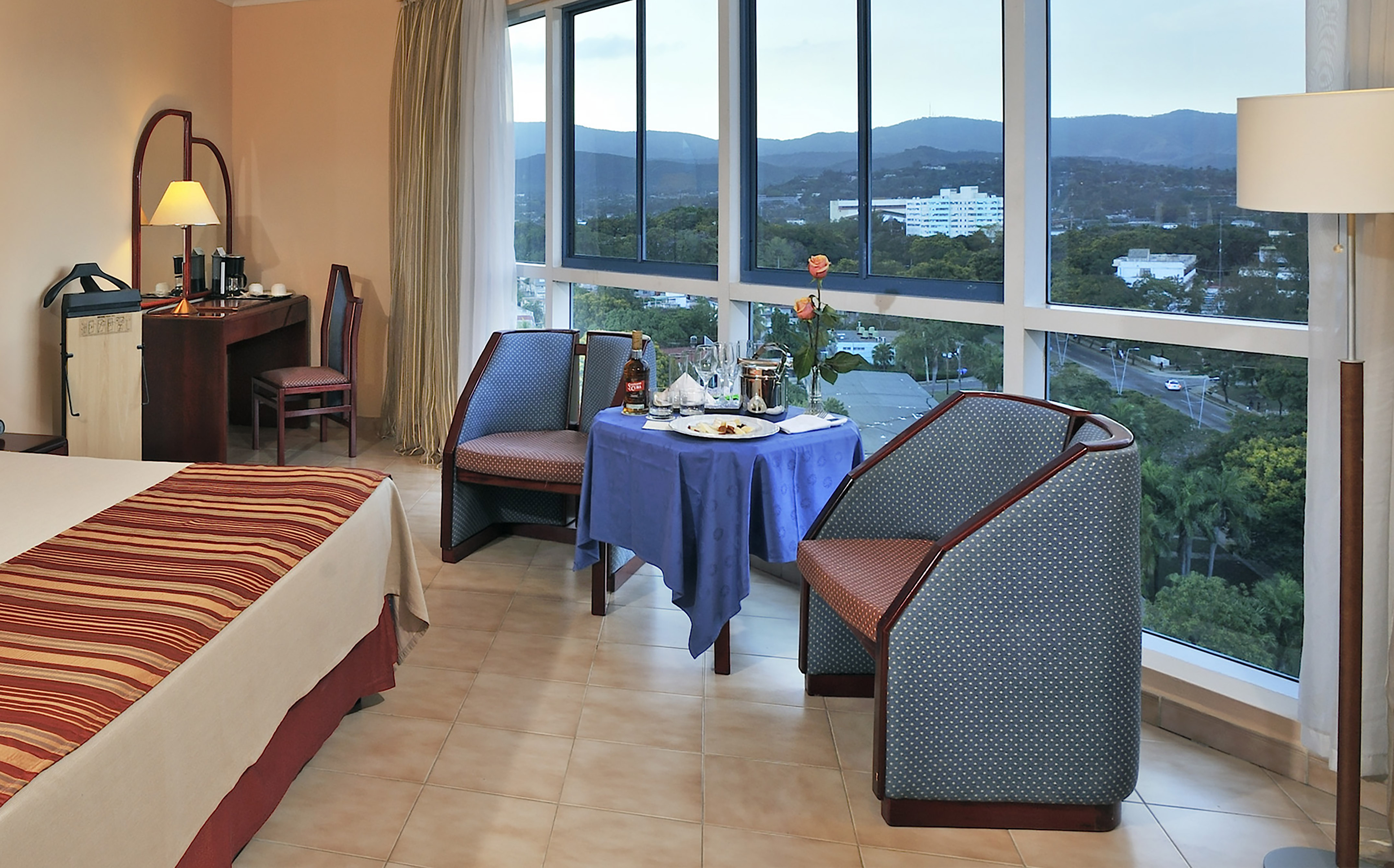 a room with a table and chairs and a view of the city