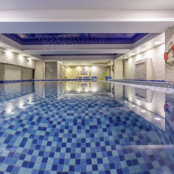 a indoor swimming pool with a blue tile floor