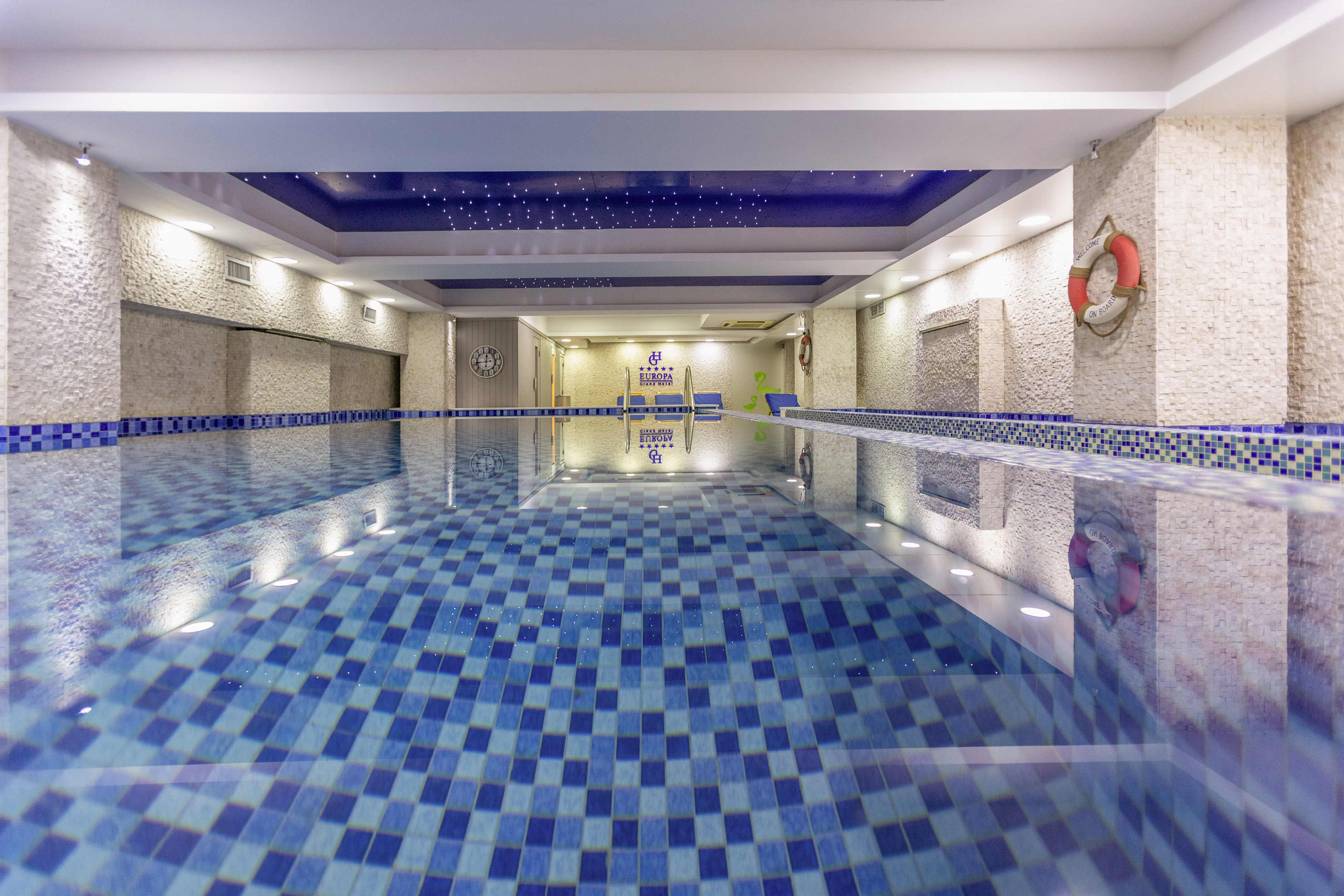 a indoor swimming pool with a blue tile floor