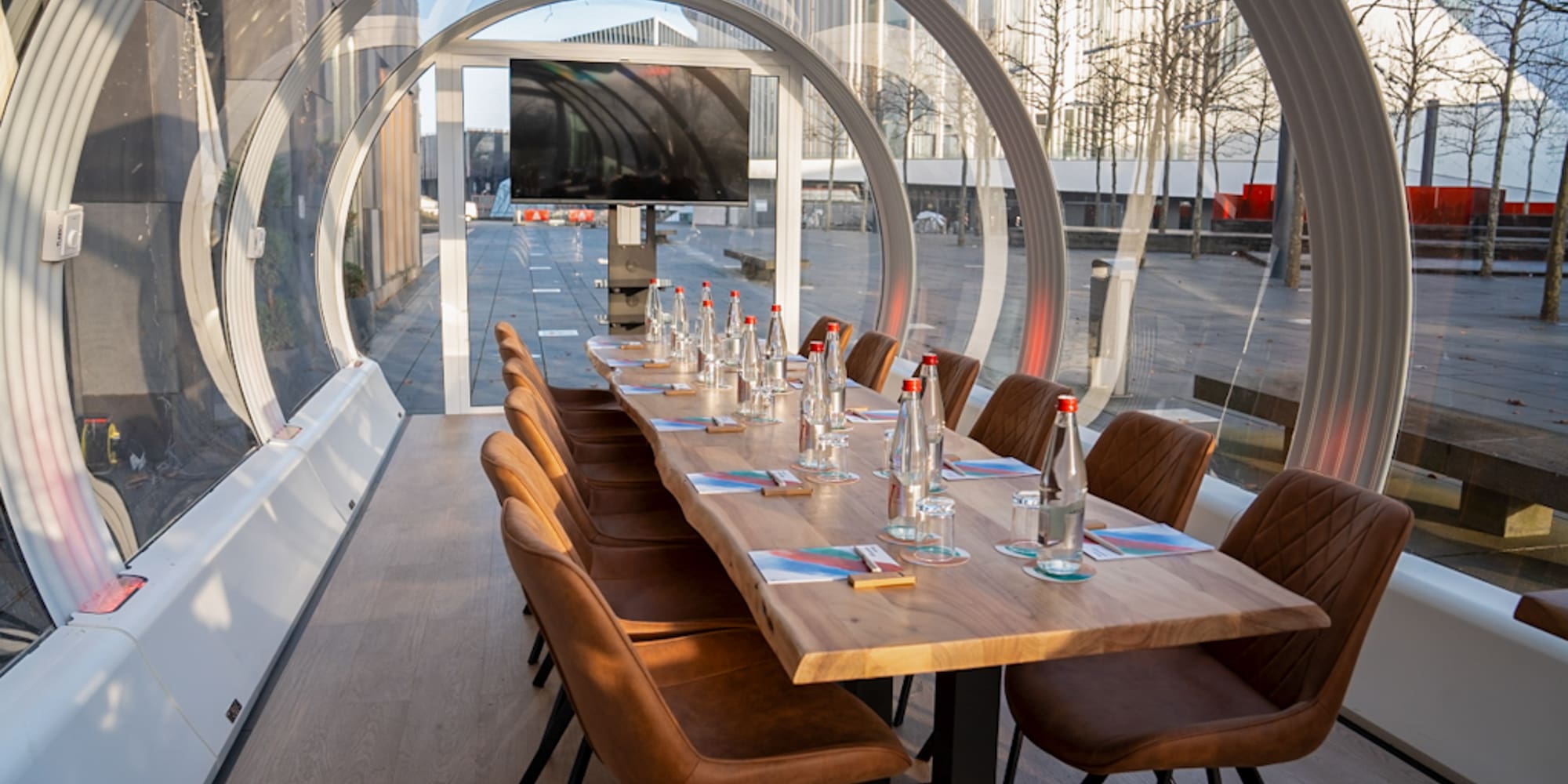a table with chairs and water bottles on it