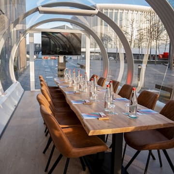 a table with chairs and water bottles on it
