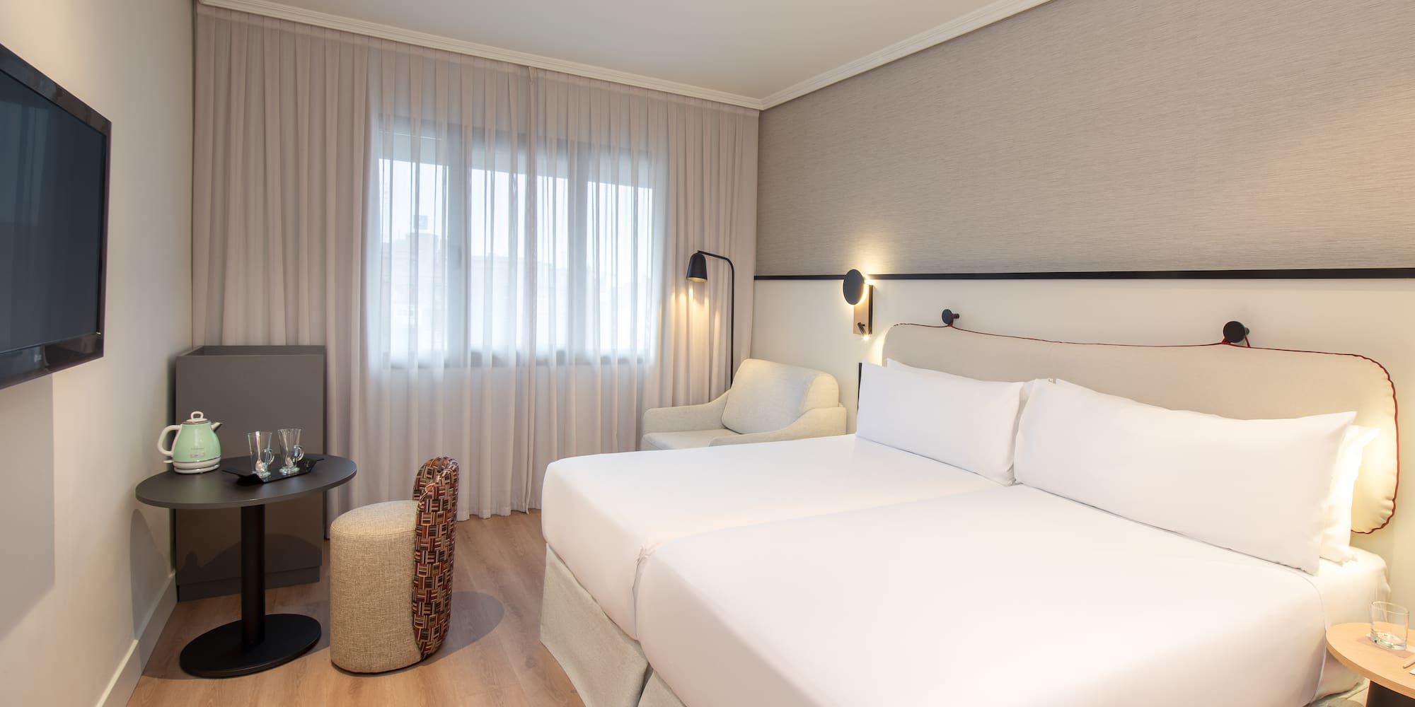 a room with two beds and a table