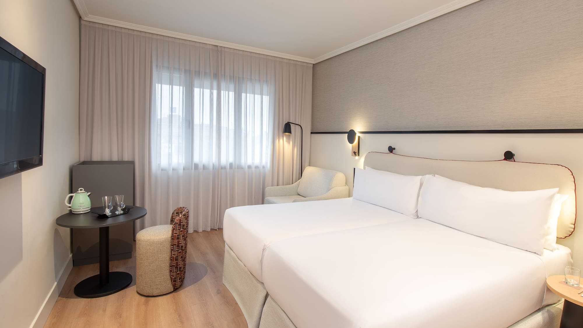 a room with two beds and a table