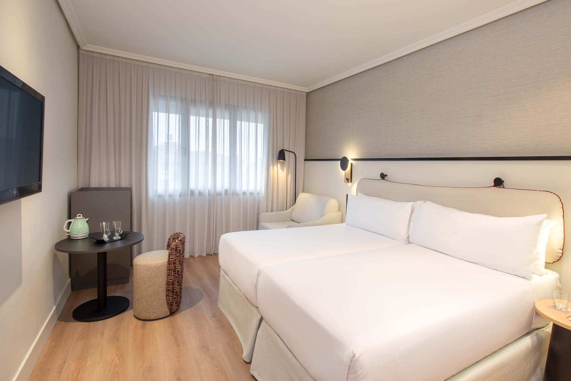 a room with two beds and a table