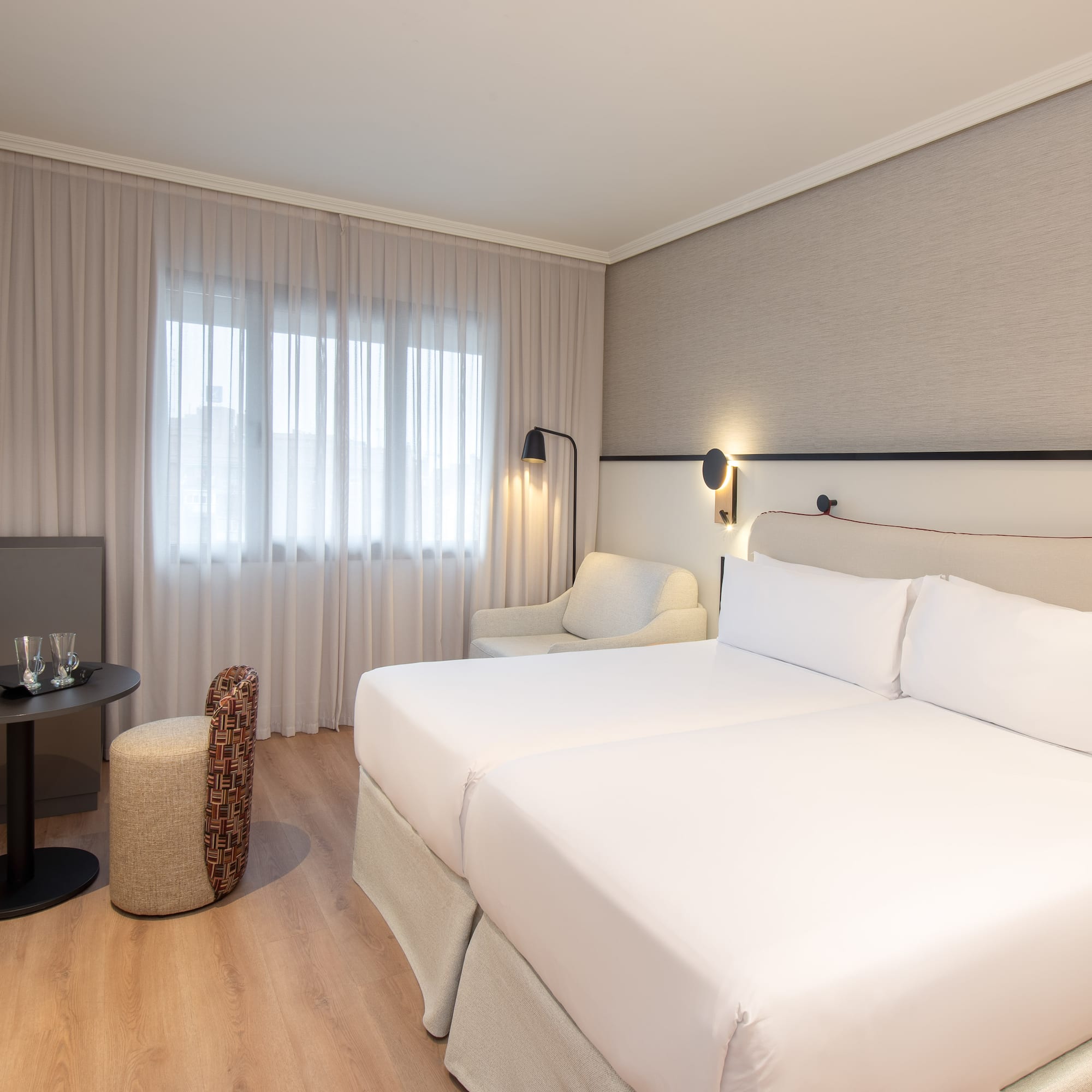 a room with two beds and a table