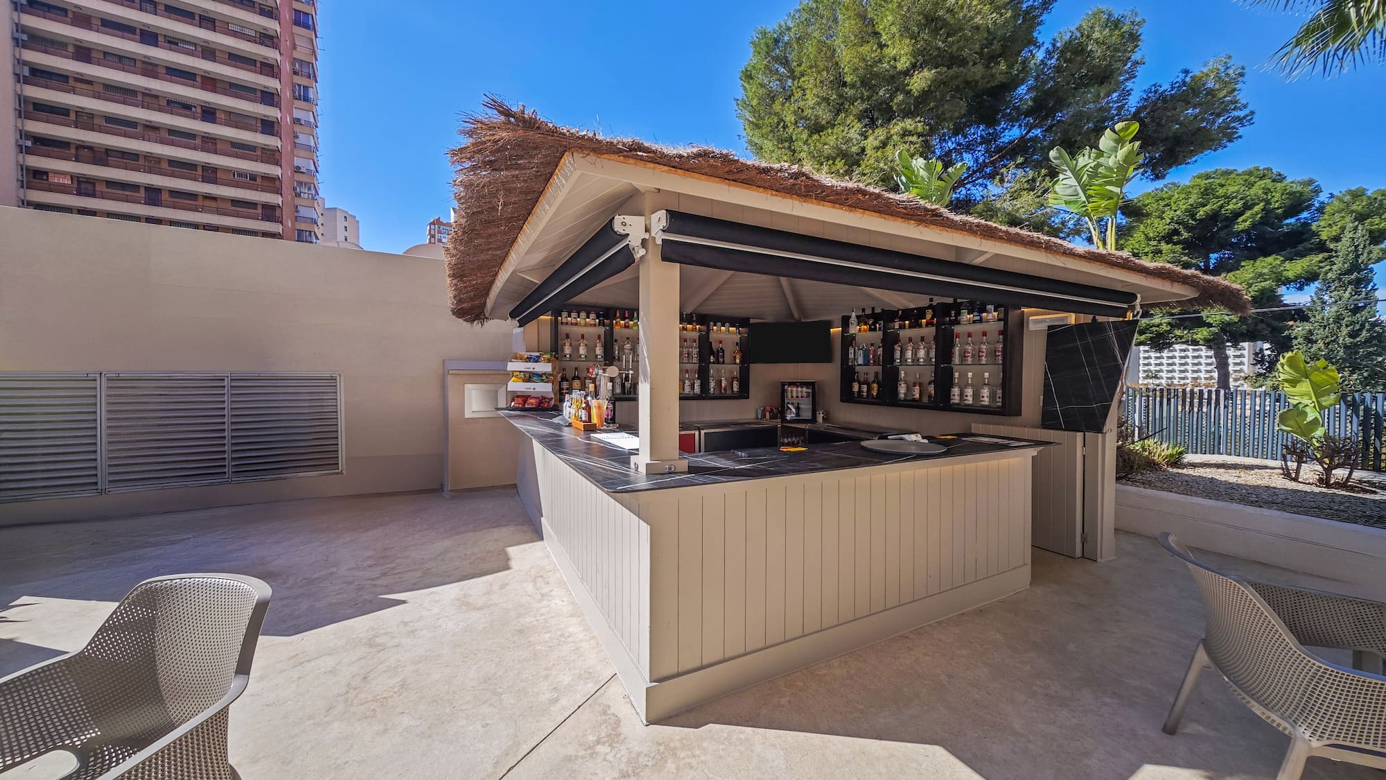 a bar outside with a straw roof