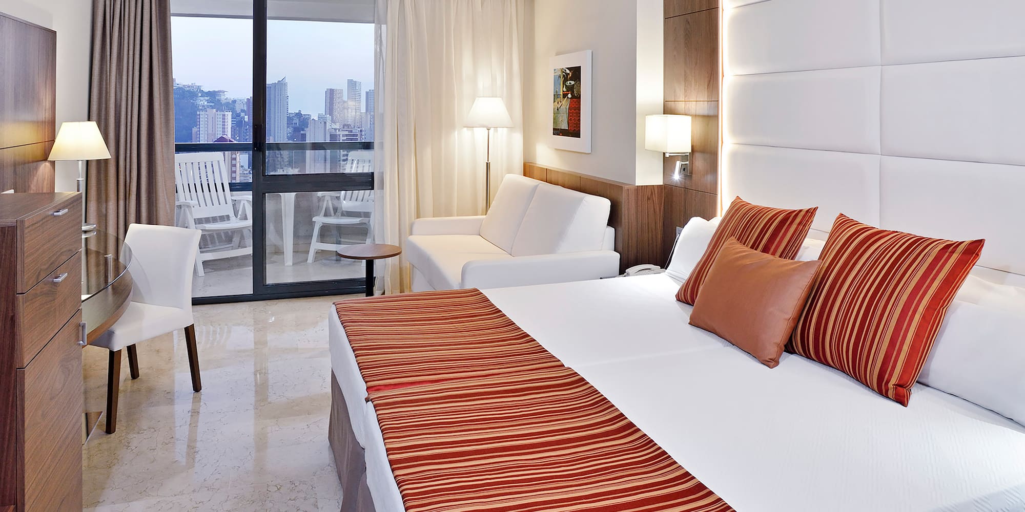 a hotel room with a bed and a couch