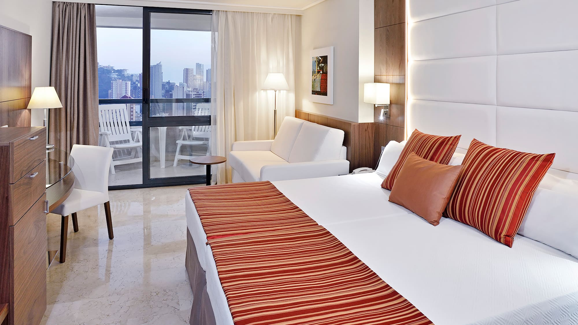 a hotel room with a bed and a couch