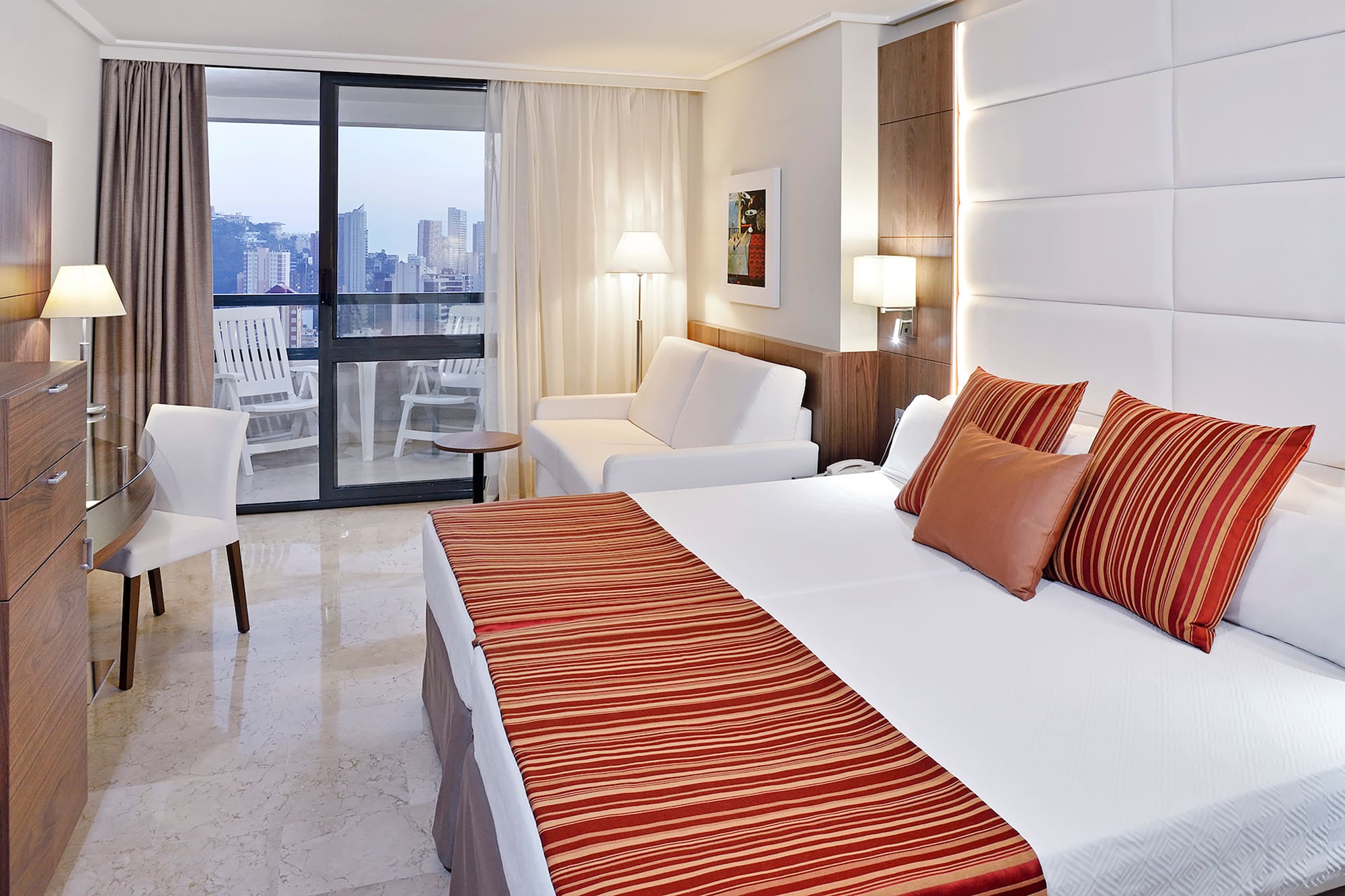 a hotel room with a bed and a couch