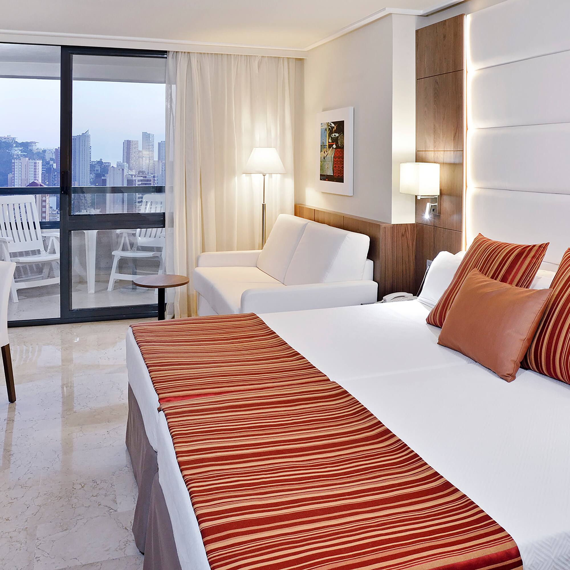 a hotel room with a bed and a couch