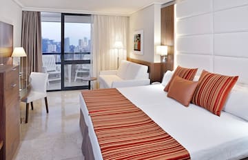 a hotel room with a bed and a couch