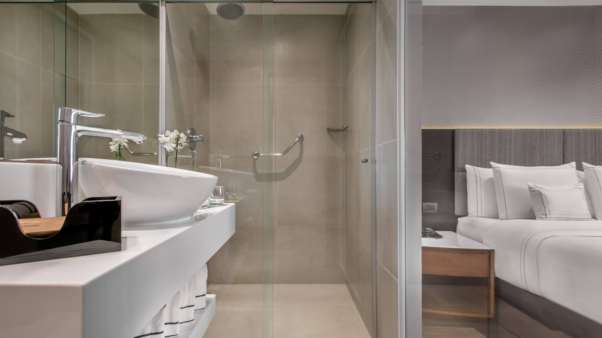 a bathroom with a glass shower door