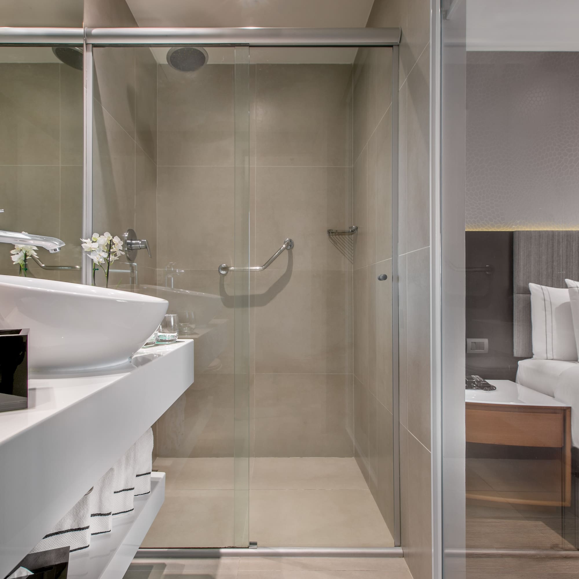 a bathroom with a glass shower door