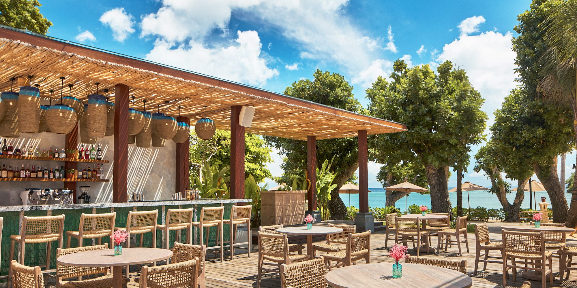 a patio with tables and chairs on a deck