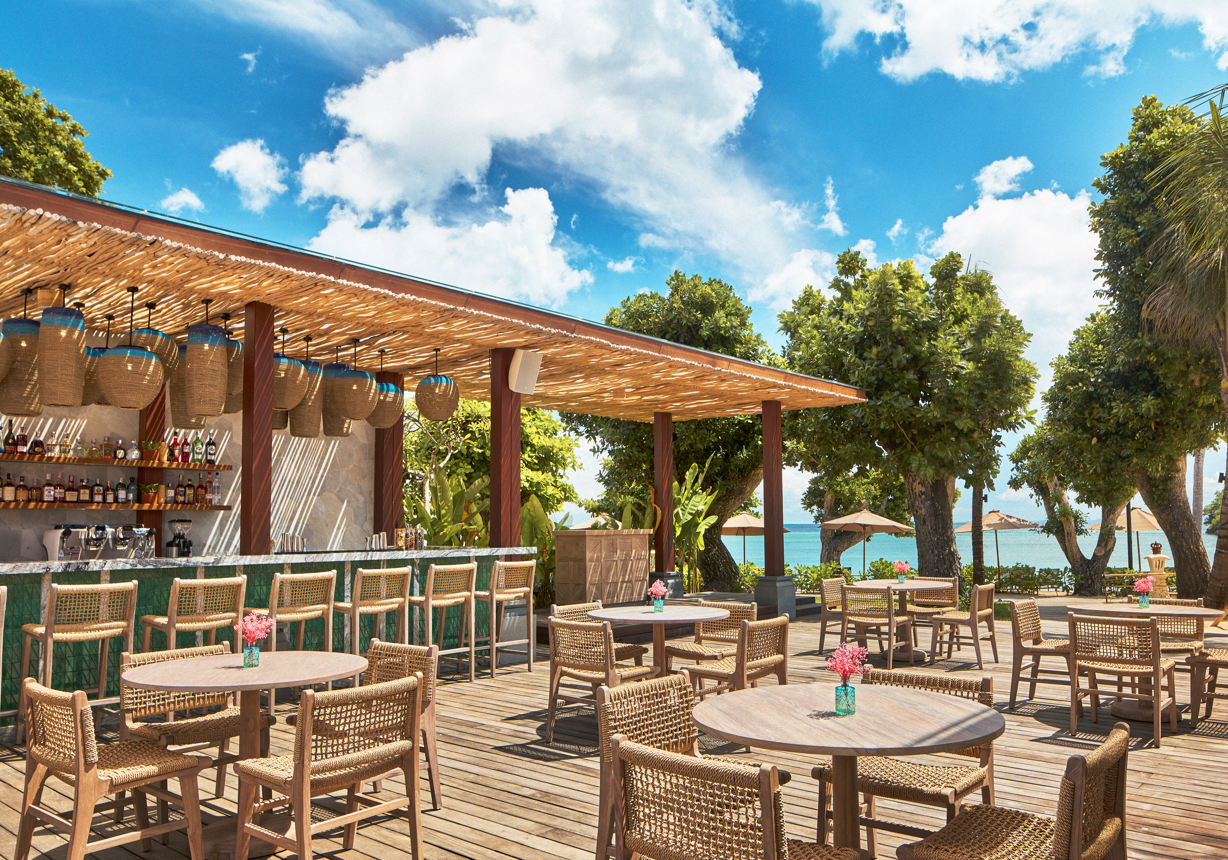 a patio with tables and chairs on a deck