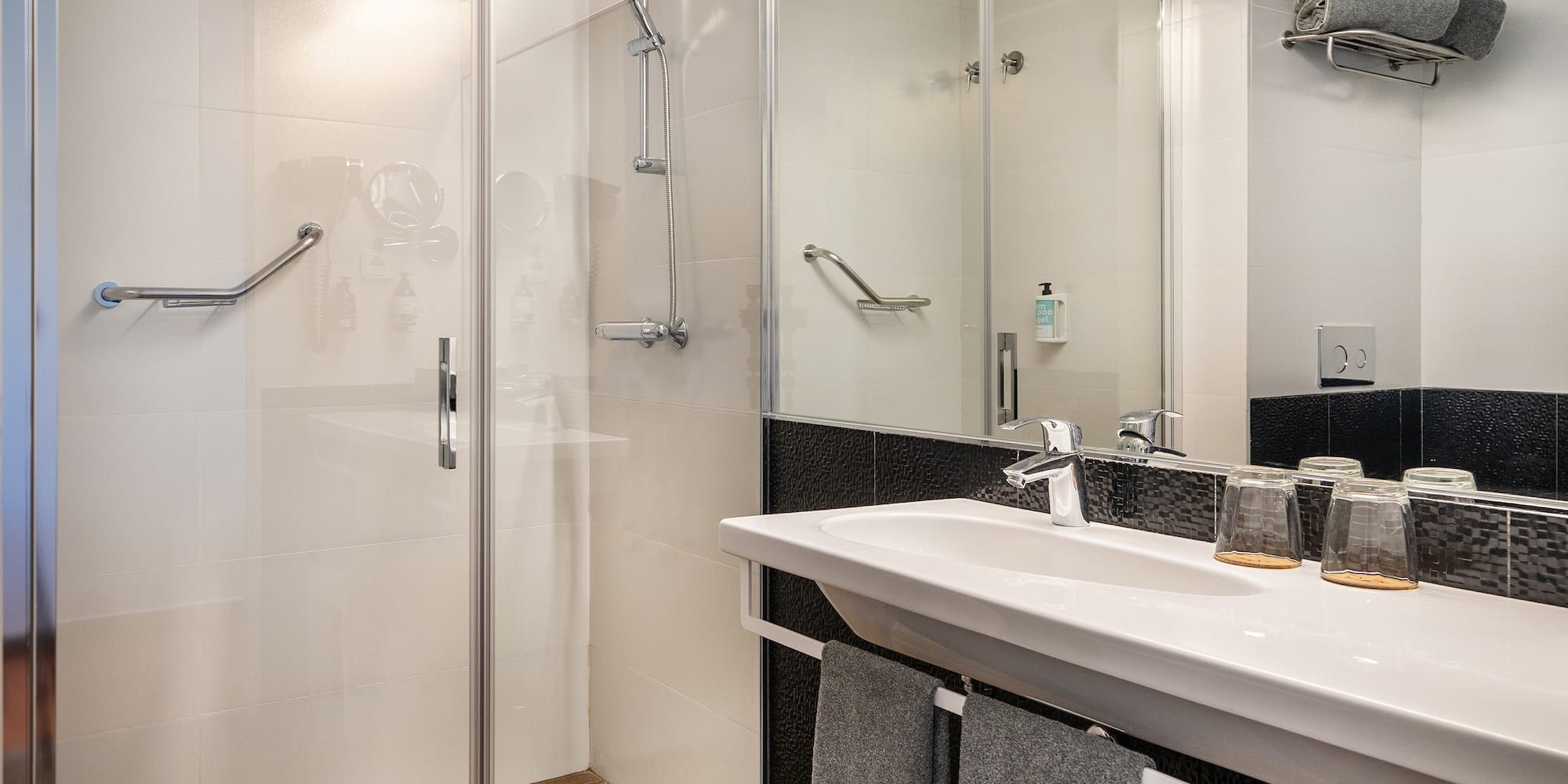 a bathroom with a shower and sink