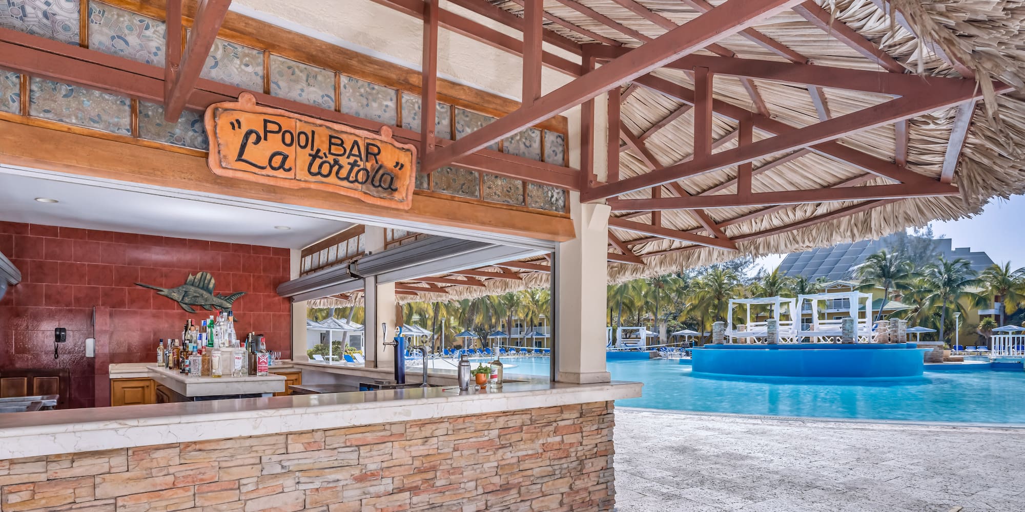 a pool bar with a pool in the background