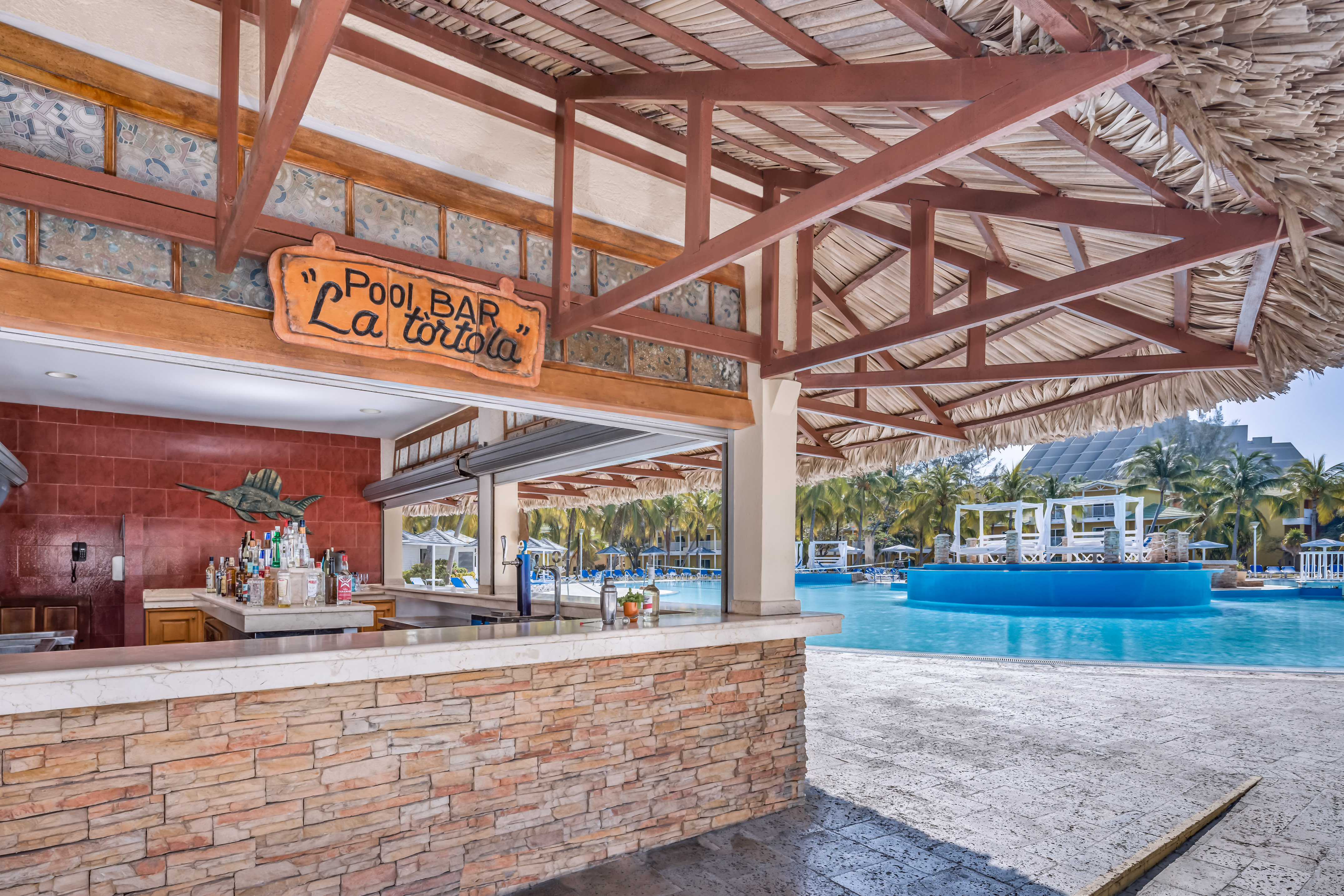 a pool bar with a pool in the background