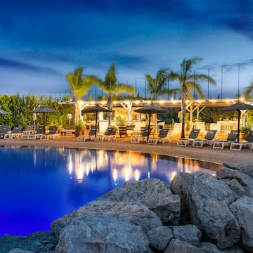 a pool with chairs and umbrellas
