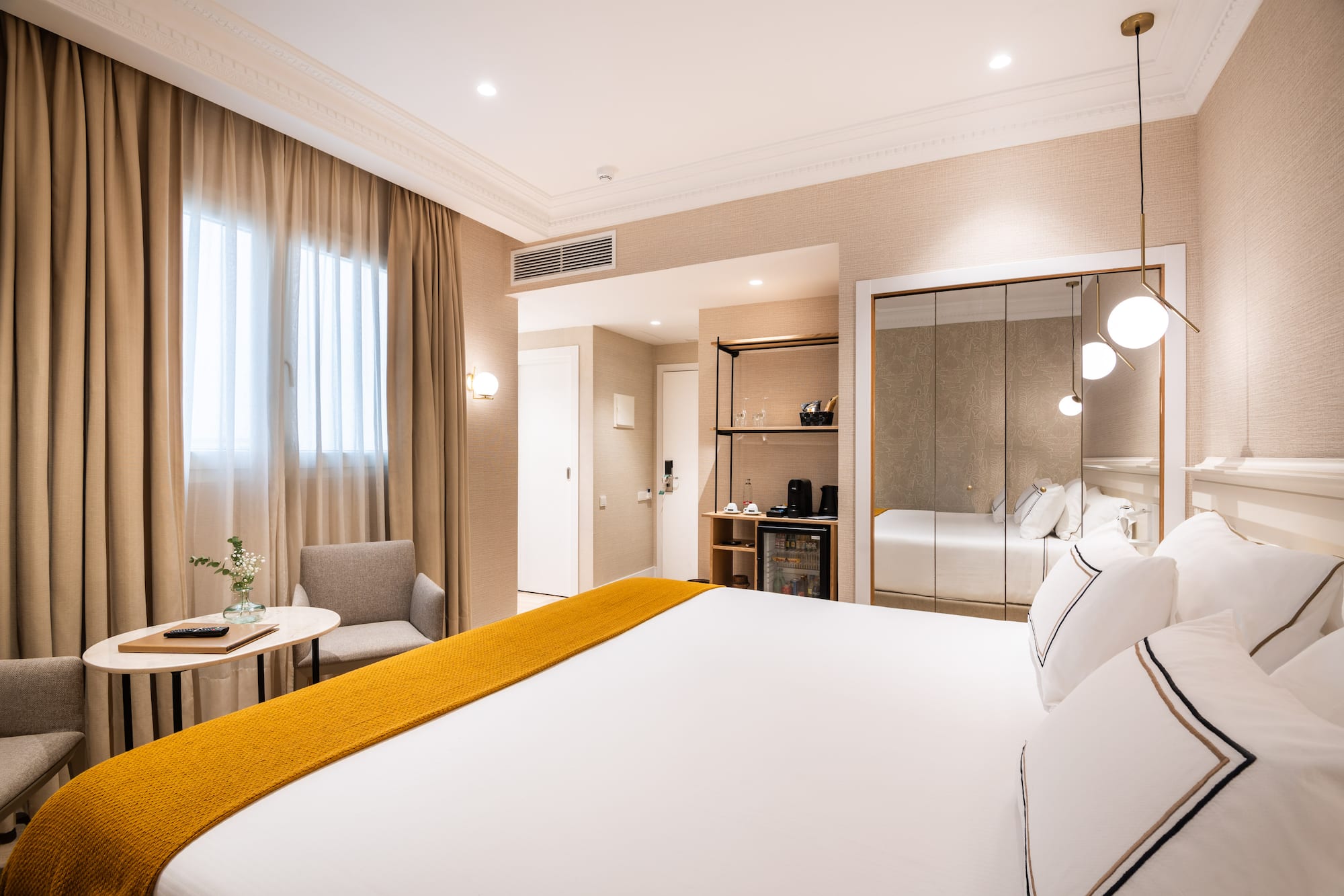 a room with a bed and a mirror